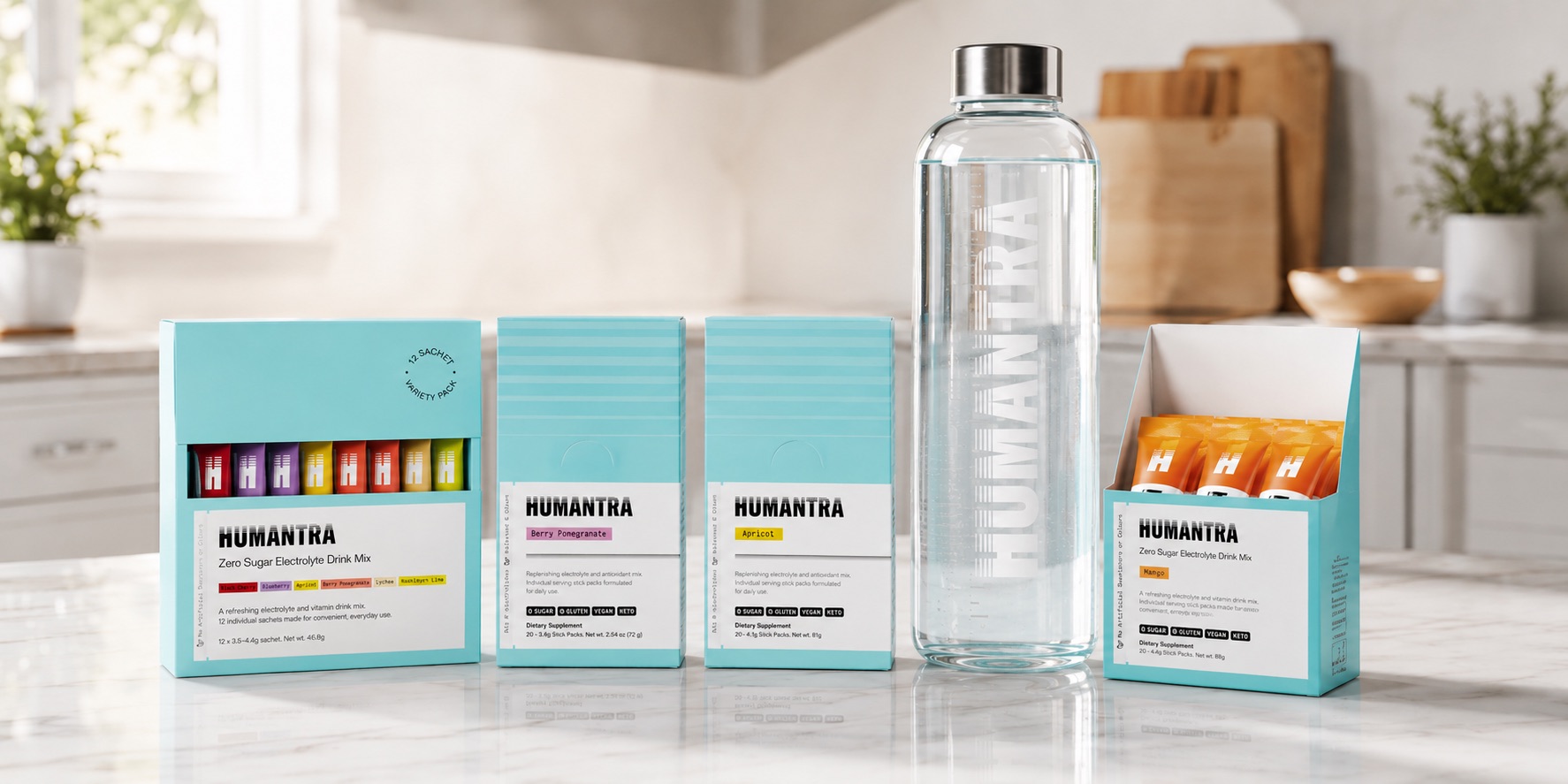 Humantra review — electrolyte sachets in several fruit flavours beside a glass water bottle
