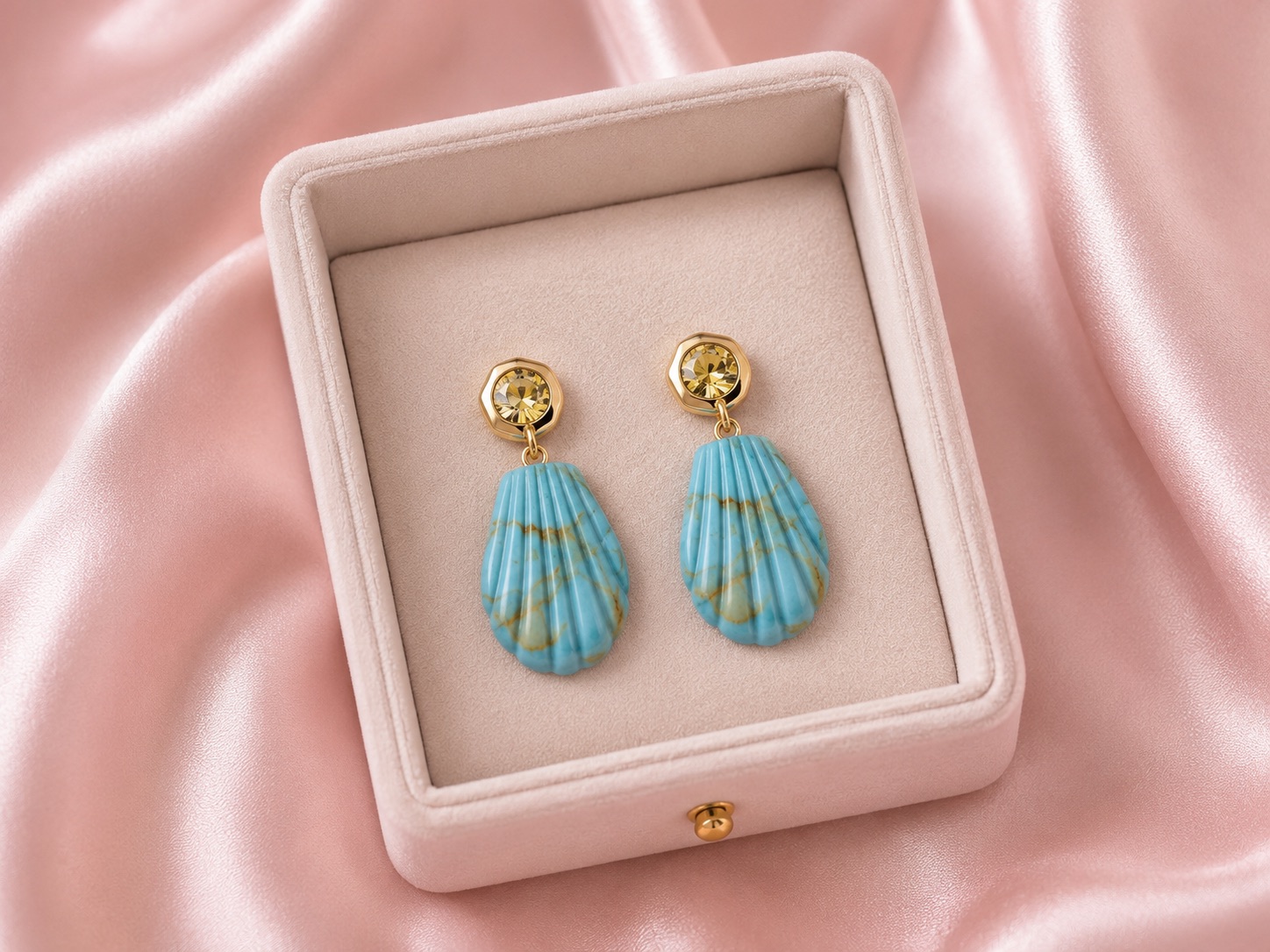 Blue shell-shaped drop earrings with gold stud tops and faceted crystal detail