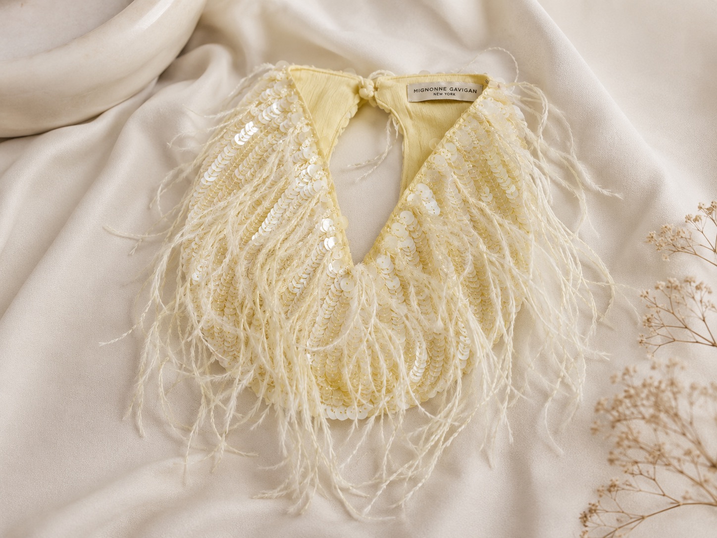 Yellow embellished scarf with sequins, feather trim, and soft textured detailing
