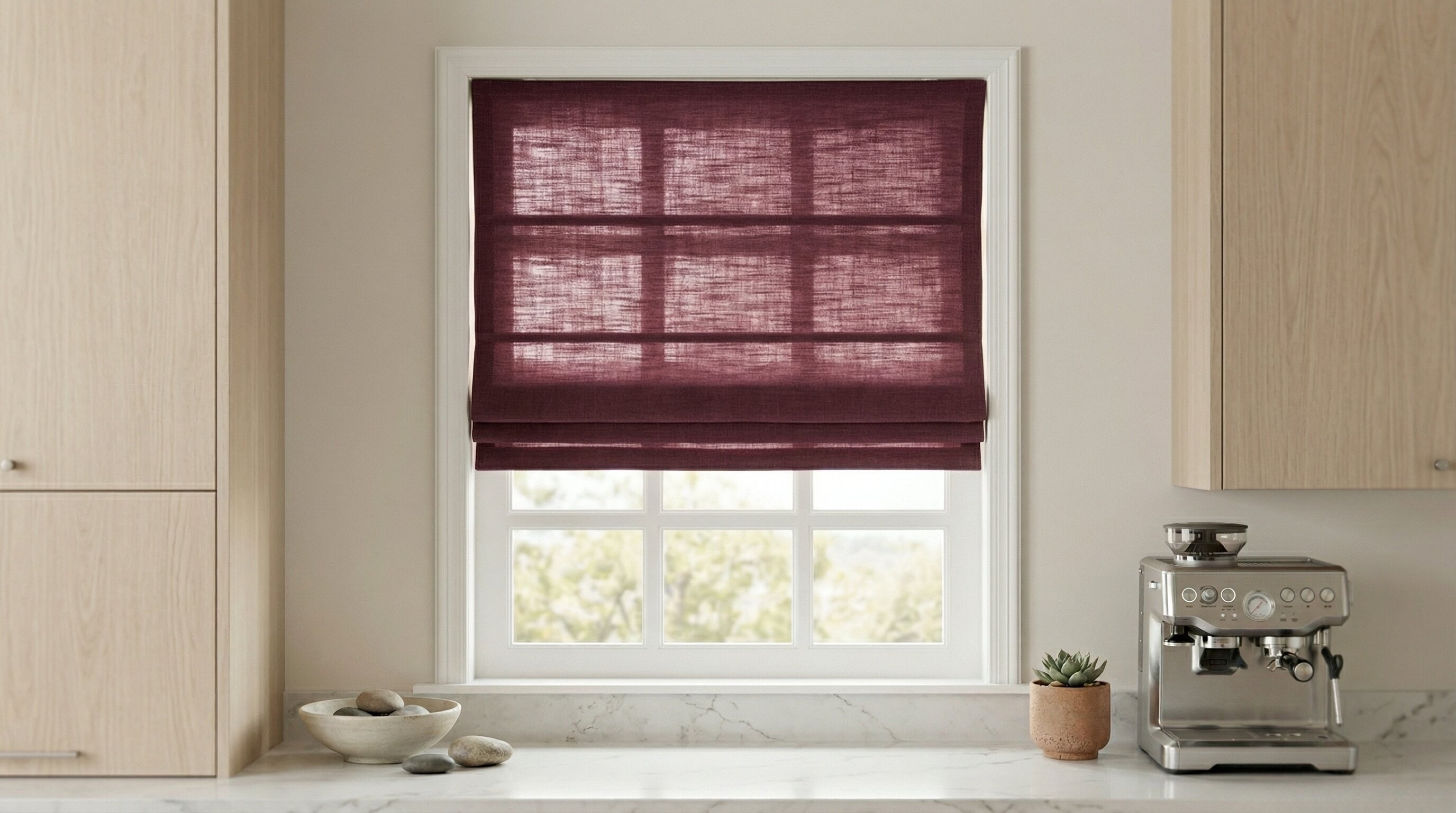 TWOPAGES Liz linen cordless Roman shade installed inside a kitchen window frame.